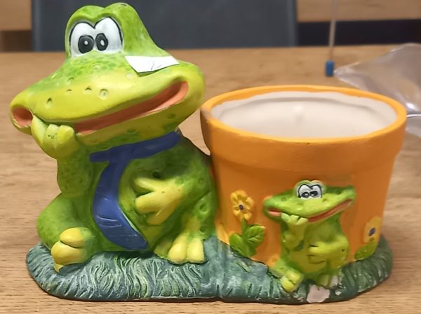 Pot de fleur décorative avec une statuette de grenouille.
